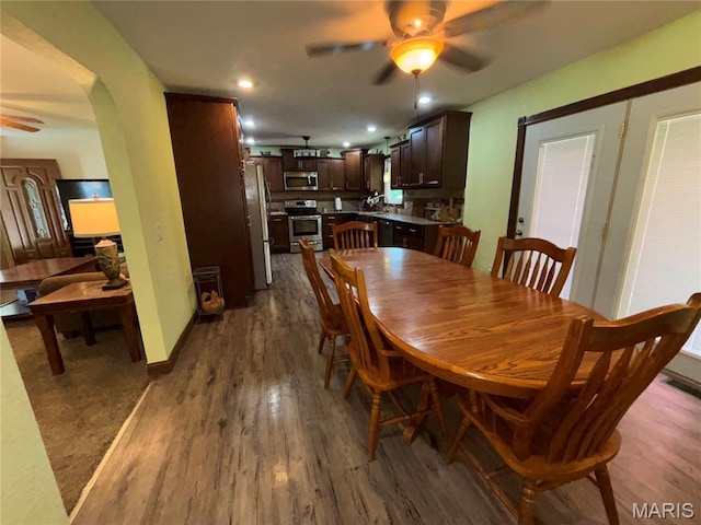 208 E Main St, Iberia, MO 65486 - dining area featuring a ceiling fan, dark wood-style floors, recessed lighting, and arched walkways