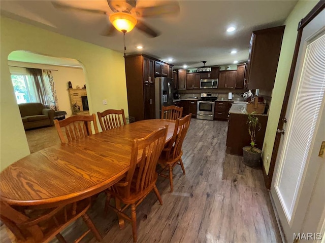 208 E Main St, Iberia, MO 65486 - dining room with wood finished floors, ceiling fan, recessed lighting, and arched walkways