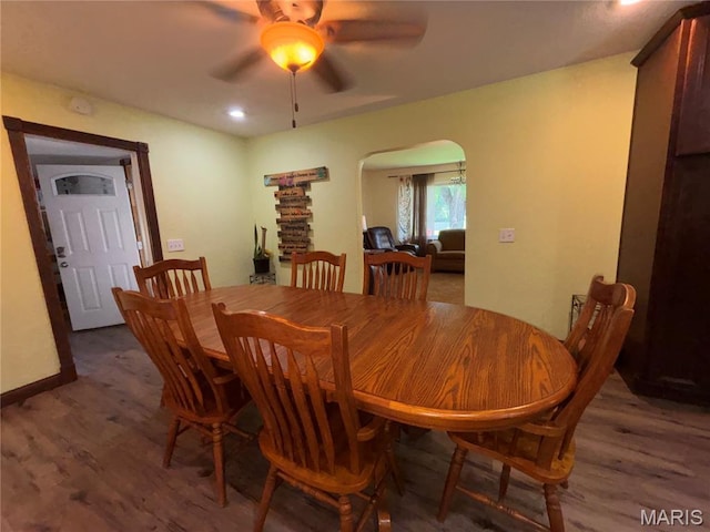 208 E Main St, Iberia, MO 65486 - dining room featuring arched walkways, wood finished floors, a ceiling fan, and recessed lighting