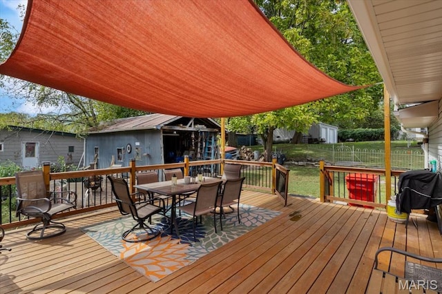 208 E Main St, Iberia, MO 65486 - deck with outdoor dining space, grilling area, and an outbuilding