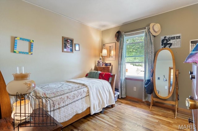 208 E Main St, Iberia, MO 65486 - bedroom with wood finished floors and baseboards