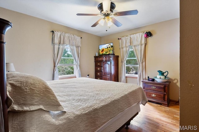208 E Main St, Iberia, MO 65486 - bedroom with multiple windows, wood finished floors, and a ceiling fan