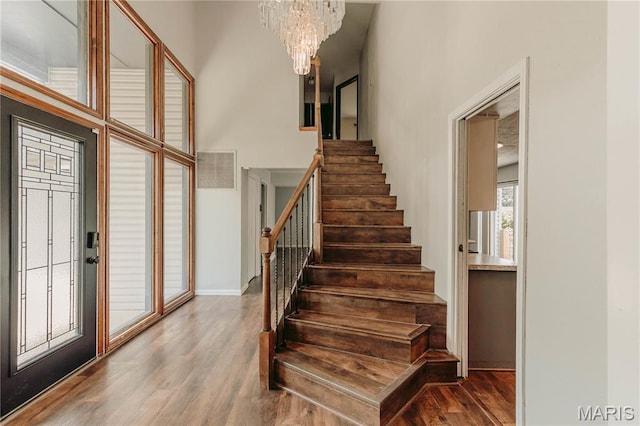 20055 Simmons Rd, Waynesville, MO 65583 - stairway with wood finished floors and a chandelier