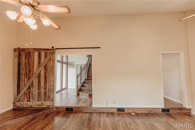 20055 Simmons Rd, Waynesville, MO 65583 - spare room featuring ceiling fan, wood finished floors, and stairs