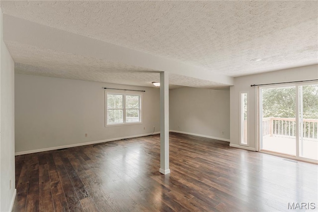 20055 Simmons Rd, Waynesville, MO 65583 - empty room featuring a textured ceiling and dark wood-style floors