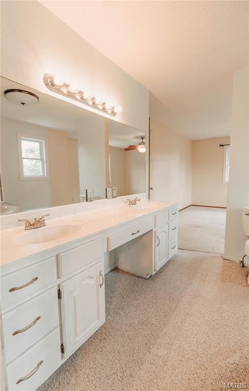 20055 Simmons Rd, Waynesville, MO 65583 - full bath featuring carpet, double vanity, and ceiling fan