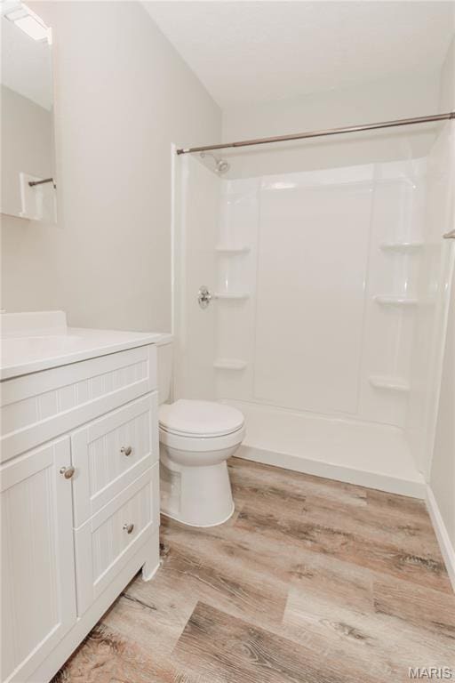20055 Simmons Rd, Waynesville, MO 65583 - bathroom with vanity, wood finished floors, and a shower