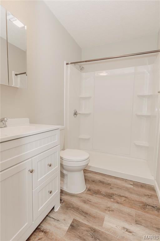 20055 Simmons Rd, Waynesville, MO 65583 - bathroom featuring vanity, wood finished floors, and a shower