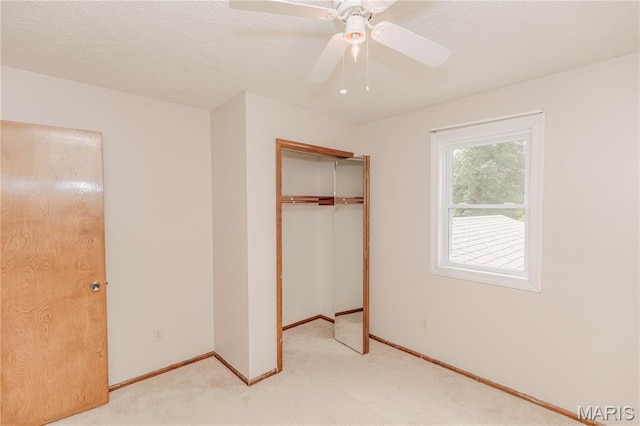 20055 Simmons Rd, Waynesville, MO 65583 - unfurnished bedroom featuring light colored carpet, a closet, a ceiling fan, and a textured ceiling