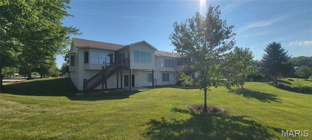 2154 Ingalls Cir Unit 1451C, Ofallon, MO 63368 - rear view of property featuring a yard and stairs