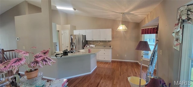 2154 Ingalls Cir Unit 1451C, Ofallon, MO 63368 - kitchen with stainless steel refrigerator with ice dispenser, light countertops, wood finished floors, white cabinetry, and decorative light fixtures