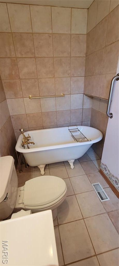 11112 Morrow Dr, Saint Ann, MO 63074 - full bathroom with a soaking tub, tile patterned floors, and tile walls