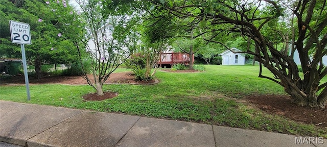 11112 Morrow Dr, Saint Ann, MO 63074 - view of grassy yard with a deck and an outdoor structure
