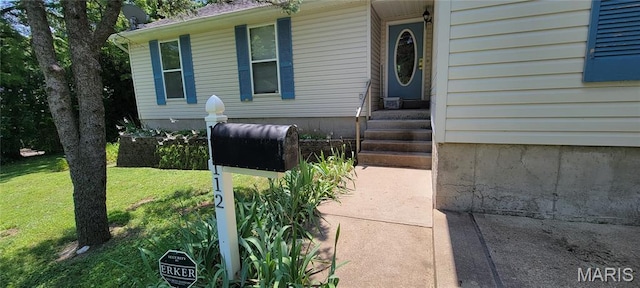 11112 Morrow Dr, Saint Ann, MO 63074 - view of exterior entry with a yard