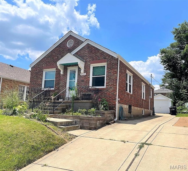5105 Lenox Ave, Shrewsbury, MO 63119 - view of front of house with brick siding, an outbuilding, a front lawn, and a detached garage