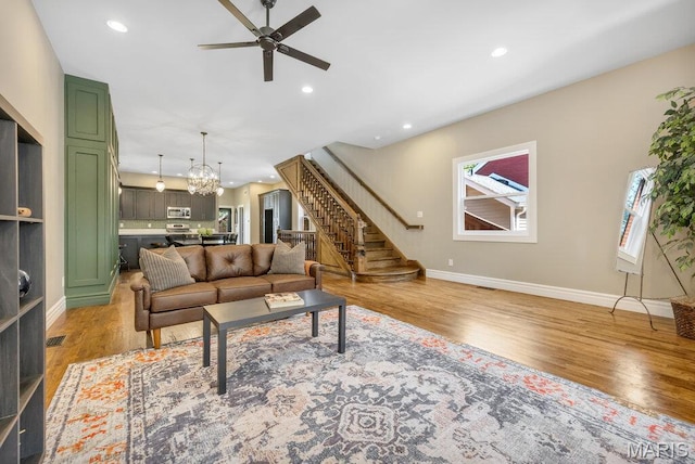 909 S 4th St, Saint Charles, MO 63301 - living room with stairs, light wood finished floors, a chandelier, ceiling fan, and recessed lighting