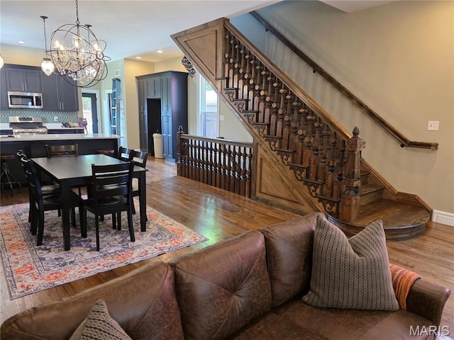 909 S 4th St, Saint Charles, MO 63301 - dining area with wood finished floors, stairs, a chandelier, and recessed lighting