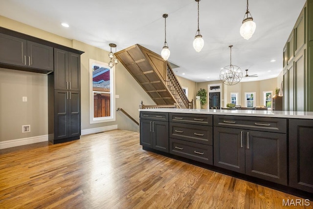 909 S 4th St, Saint Charles, MO 63301 - kitchen with light wood-style floors, light countertops, hanging light fixtures, a chandelier, and recessed lighting
