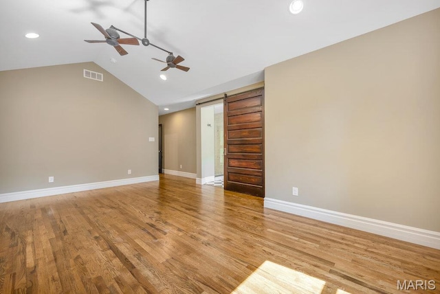 909 S 4th St, Saint Charles, MO 63301 - unfurnished living room featuring a ceiling fan, vaulted ceiling, recessed lighting, light wood finished floors, and a barn door