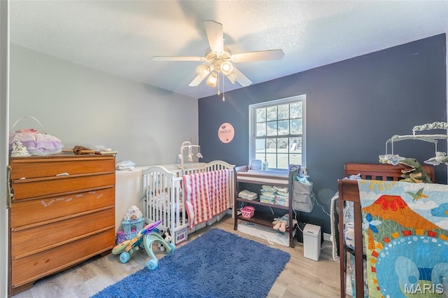 2635 Linda Ln, Poplar Bluff, MO 63901 - bedroom featuring wood finished floors, a ceiling fan, and a textured ceiling