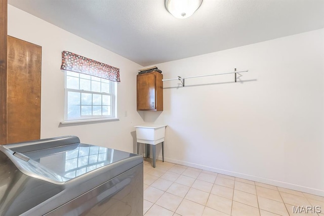 2635 Linda Ln, Poplar Bluff, MO 63901 - washroom featuring cabinet space, washer and clothes dryer, and light tile patterned floors