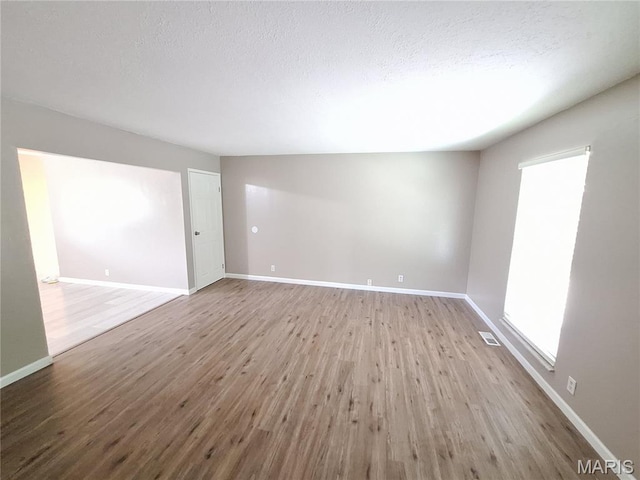 2465 Stoney End Ct, Florissant, MO 63031 - unfurnished room featuring wood finished floors and a textured ceiling
