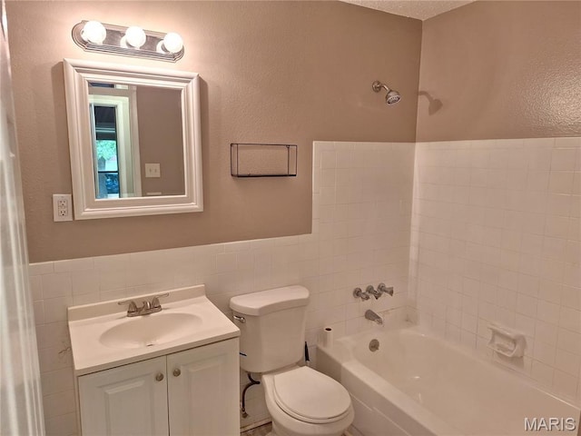 2465 Stoney End Ct, Florissant, MO 63031 - full bathroom with tile walls, vanity, a wainscoted wall, and bathtub / shower combination