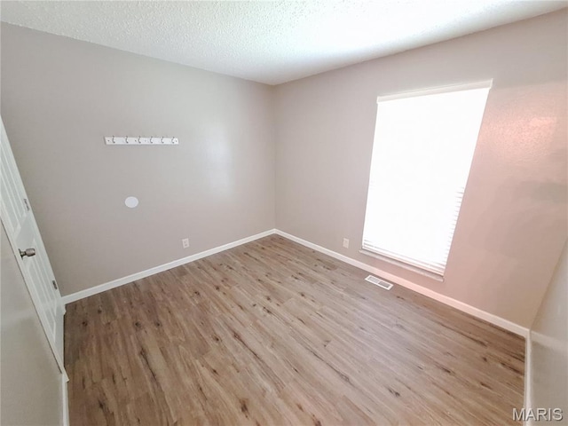 2465 Stoney End Ct, Florissant, MO 63031 - unfurnished room featuring wood finished floors and a textured ceiling
