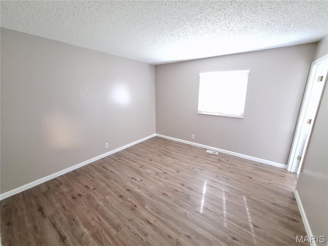 2465 Stoney End Ct, Florissant, MO 63031 - empty room featuring wood finished floors and a textured ceiling