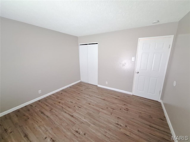 2465 Stoney End Ct, Florissant, MO 63031 - unfurnished bedroom with wood finished floors and a closet