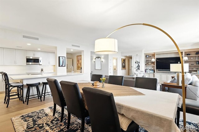 200 S Brentwood Blvd Unit 15C, Clayton, MO 63105 - dining room featuring crown molding, light wood-style flooring, and recessed lighting