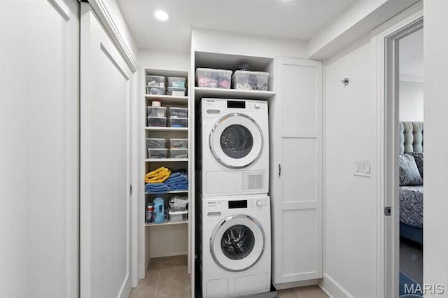 200 S Brentwood Blvd Unit 15C, Clayton, MO 63105 - washroom with estacked washer and dryer and recessed lighting