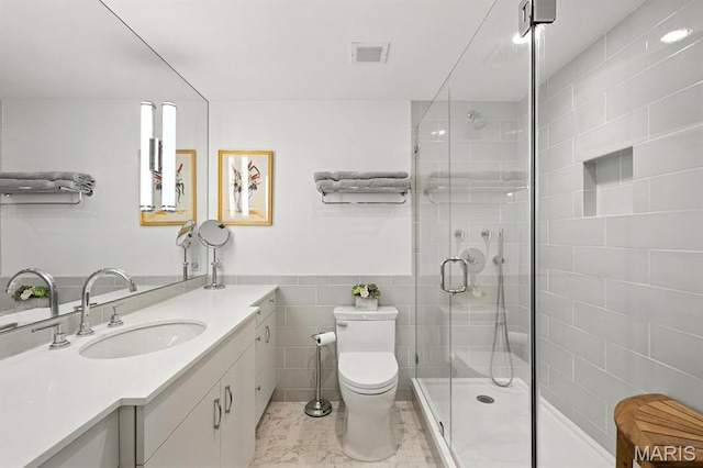 200 S Brentwood Blvd Unit 15C, Clayton, MO 63105 - bathroom featuring vanity, a shower stall, and tile walls
