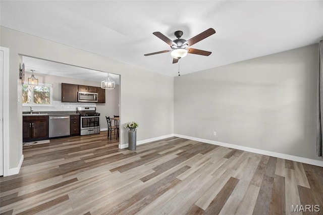4035 Mary Ridge Ln, Saint Charles, MO 63304 - unfurnished living room with light wood-style floors, ceiling fan, and a chandelier