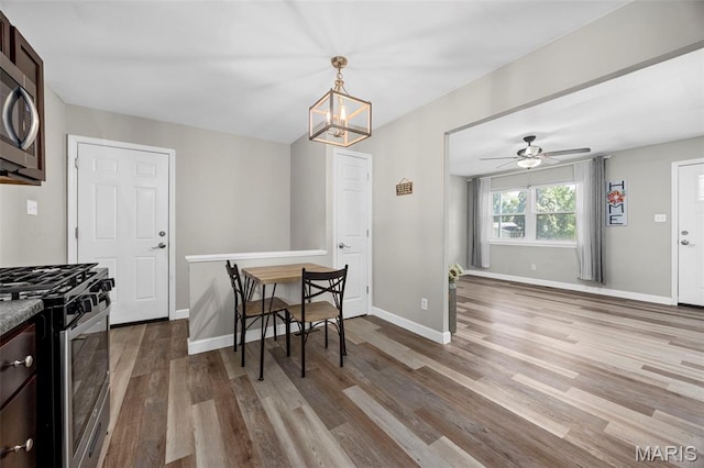 4035 Mary Ridge Ln, Saint Charles, MO 63304 - dining space with wood finished floors, a chandelier, and ceiling fan