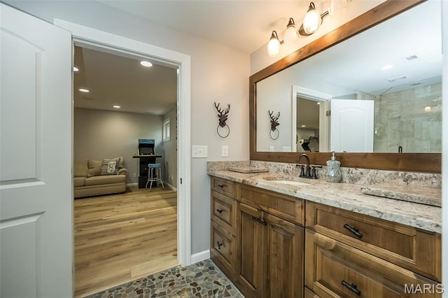 14703 Kulkarni Ct, Chesterfield, MO 63017 - full bath featuring vanity, tiled shower, wood finished floors, and recessed lighting