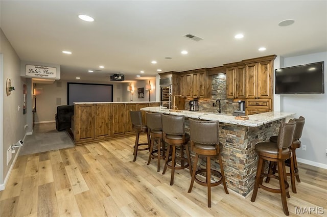 14703 Kulkarni Ct, Chesterfield, MO 63017 - bar area featuring recessed lighting, light wood finished floors, and backsplash