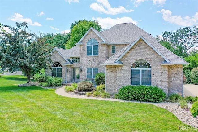 15 Fox Mill Dr, Maryville, IL 62062 - traditional-style home with a front lawn, brick siding, and a shingled roof