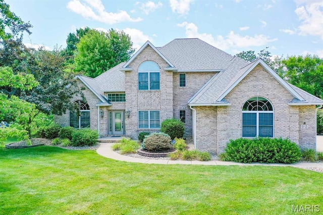 15 Fox Mill Dr, Maryville, IL 62062 - view of front facade with brick siding, a front lawn, and a shingled roof