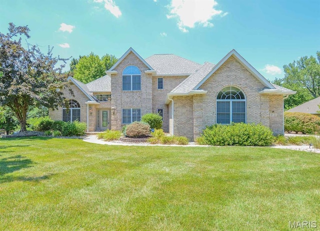 15 Fox Mill Dr, Maryville, IL 62062 - traditional-style home featuring brick siding, a front yard, and roof with shingles