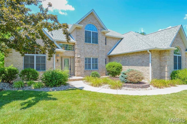 15 Fox Mill Dr, Maryville, IL 62062 - traditional-style home with brick siding, roof with shingles, and a front lawn