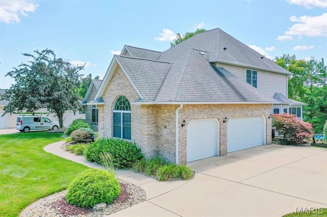 15 Fox Mill Dr, Maryville, IL 62062 - view of home's exterior with a garage, brick siding, driveway, a yard, and roof with shingles