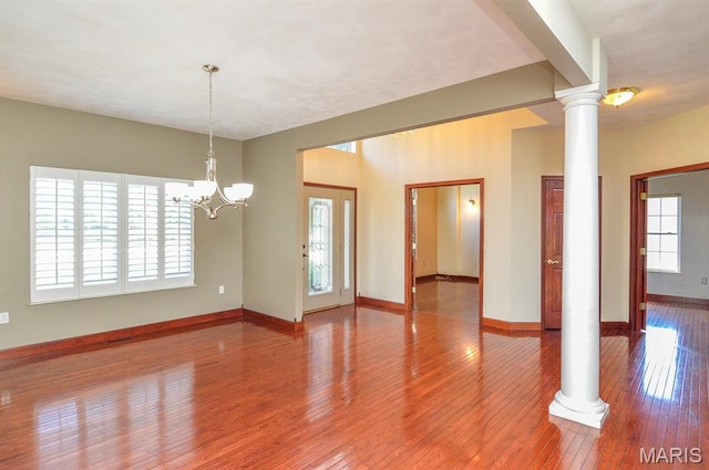 15 Fox Mill Dr, Maryville, IL 62062 - empty room with ornate columns, hardwood / wood-style floors, and a chandelier