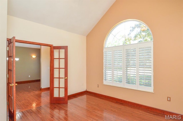 15 Fox Mill Dr, Maryville, IL 62062 - empty room featuring french doors, wood finished floors, and high vaulted ceiling