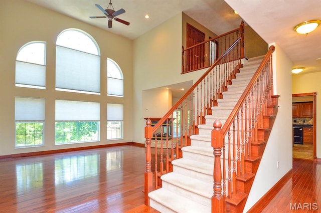 15 Fox Mill Dr, Maryville, IL 62062 - stairway featuring a ceiling fan, hardwood / wood-style floors, and a high ceiling