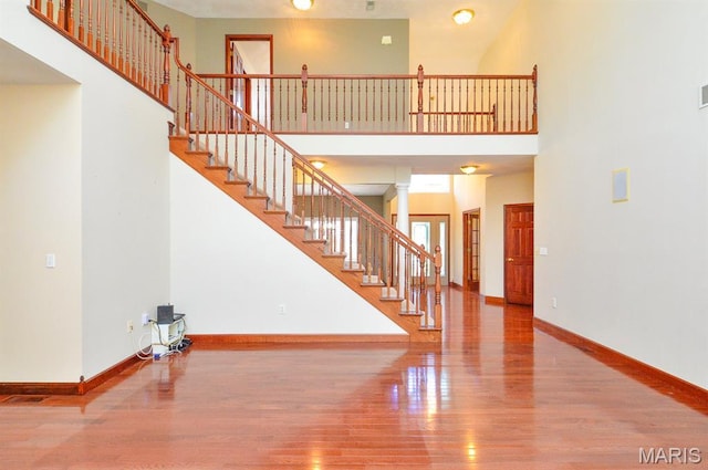 15 Fox Mill Dr, Maryville, IL 62062 - unfurnished living room with wood finished floors, stairway, and a high ceiling