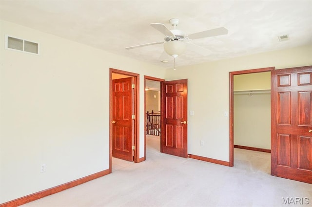 15 Fox Mill Dr, Maryville, IL 62062 - unfurnished bedroom featuring light carpet, a walk in closet, a closet, and a ceiling fan