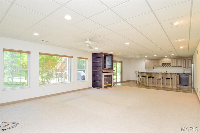 15 Fox Mill Dr, Maryville, IL 62062 - unfurnished living room featuring a large fireplace, light colored carpet, recessed lighting, bar with sink, and a ceiling fan
