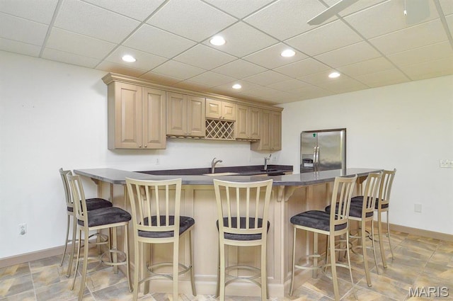 15 Fox Mill Dr, Maryville, IL 62062 - kitchen with stainless steel fridge with ice dispenser, recessed lighting, a breakfast bar, and dark countertops