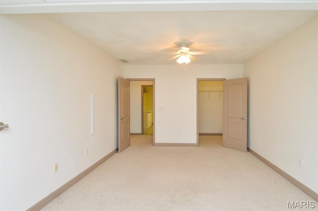 15 Fox Mill Dr, Maryville, IL 62062 - unfurnished bedroom with light colored carpet, a walk in closet, a closet, and a ceiling fan